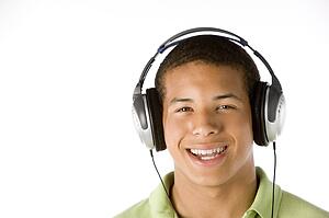 Teenage Boy Listening To Music On Headphones