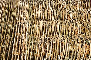 Metal fencing stacked in a row.
