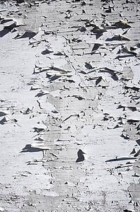 White peeling paint on old wall.