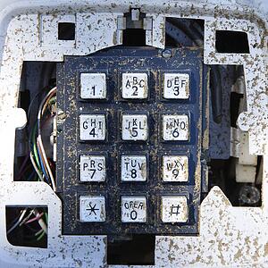 Closeup of old dirty telephone keypad.