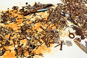 Old rusty nails and screws on table