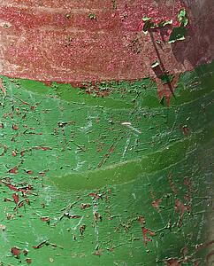 Closeup of green and red rusted container.