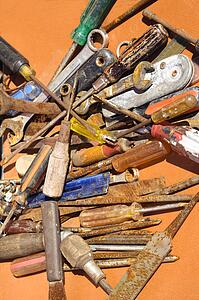 Old rusty tools lying on table.