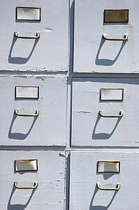 Old weathered grey cabinet outdoors.