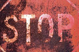 Closeup of rusty old stop sign.
