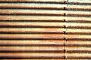 Side of building with old rusted corrugated metal.