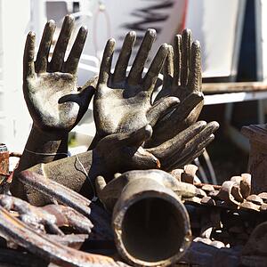 Collection of metal statuettes in a pile.