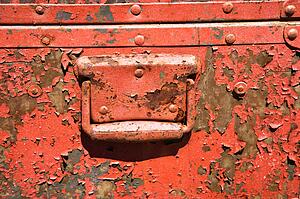 Old orange weathered metal storage container.