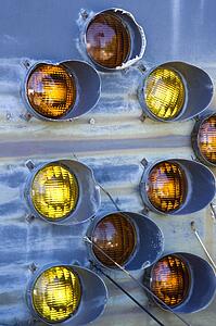 Old tail lights together on metal blue background.
