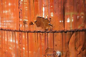 Closeup of metal orange container.