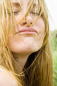 Close up portrait of blonde woman making a funny face.