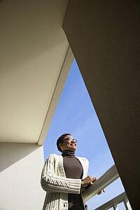 Woman looking out on a balcony