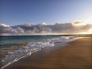 Waves lapping on the beach at dusk