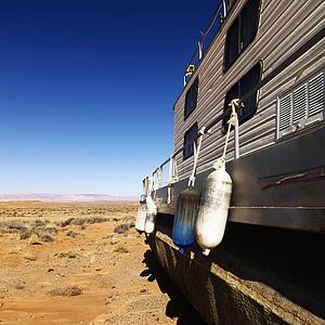 Landscape of houseboat sitting in the middle of the desert in rural Arizona, United States