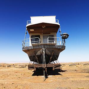 Landscape of houseboat sitting in the middle of the desert