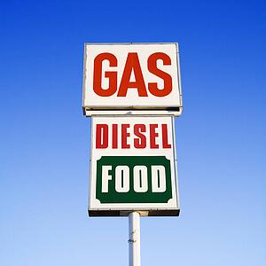 Sign against blue sky gas, diesel and food