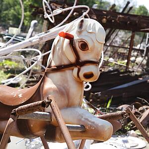Abandoned playground toy horse in junkyard