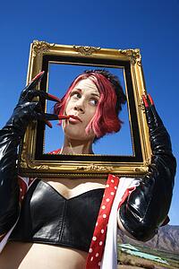 Female holding empty frame around head