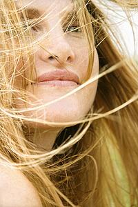 Close up portrait of attractive redheaded woman with windblown hair