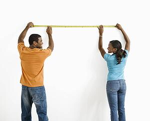 Male and female measuring wall