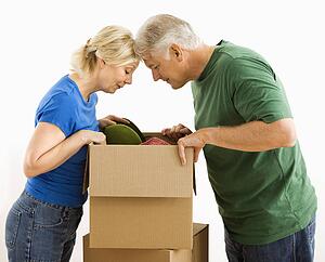 Couple looking through cardboard box