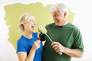 Couple playing with paint utensils.