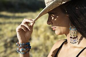Woman tipping straw cowboy hat