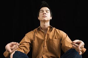 Man sitting in meditative lotus position