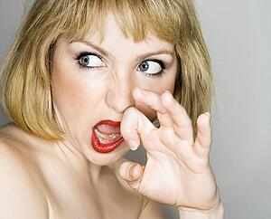 blonde woman who is looking off to the side with a disgusted expression