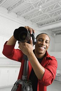 Adult with camera on tripod 