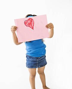 Girl showing off drawing of heart