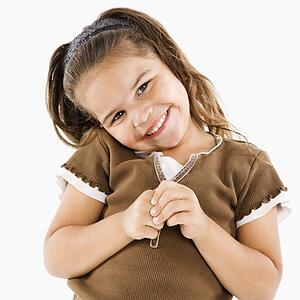 Cute little girl standing and smiling at viewer