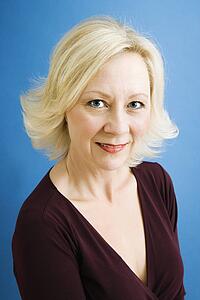 Close up studio portrait of attractive adult businesswoman looking at viewer.