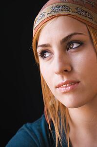 Woman wearing cap looking off to side