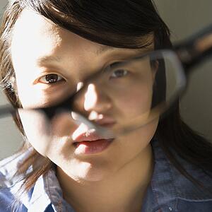 Woman holding eyeglasses