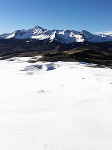 Aerial landscape of Colorado Rockies with snow covered valley