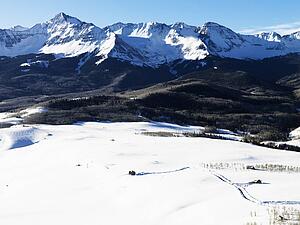 Aerial landscape of Colorado Rockies with snow covered valley