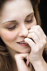 Female with hand on face