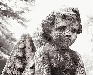 Close-up cherub statue in graveyard