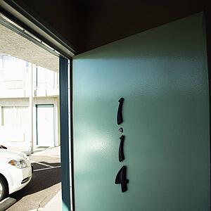 Motel room door on first floor that has been left open.