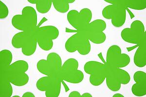 Group of green paper shamrocks on white