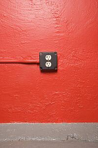 Red wall with electrical outlet