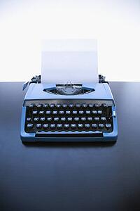 Still life of blank sheet of paper in an old fashioned typewriter
