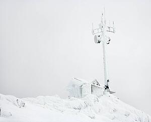Cabin and antenna covered in snow