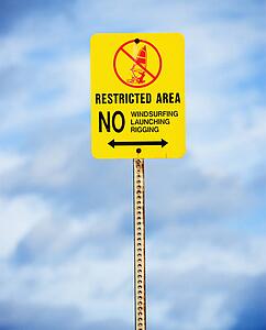 Sign near the ocean or lake warning of no windsurfing, rigging or launching.
