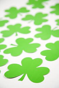 Group of green paper shamrocks on white