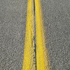 Close-up of double yellow lines in road