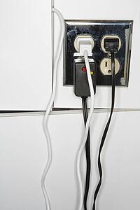 Electrical outlet with multiple plugs and cords