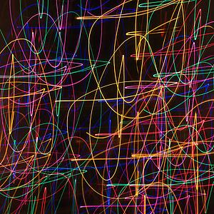 Multicolored lights forming abstract squiggle pattern from motion blur