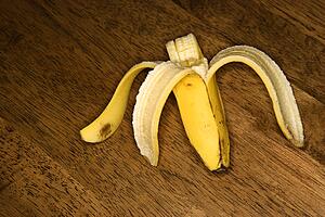 Still life of half eaten banana on wooden table